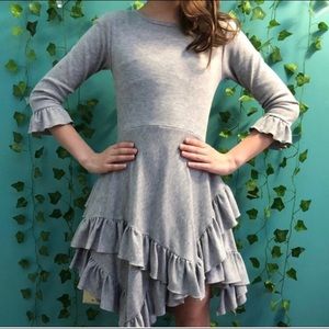 grey dress with ruffles at sleeves and bottom